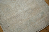 Textured pile of the distressed Oushak runner in faded platinum, beige, and sea foam green.