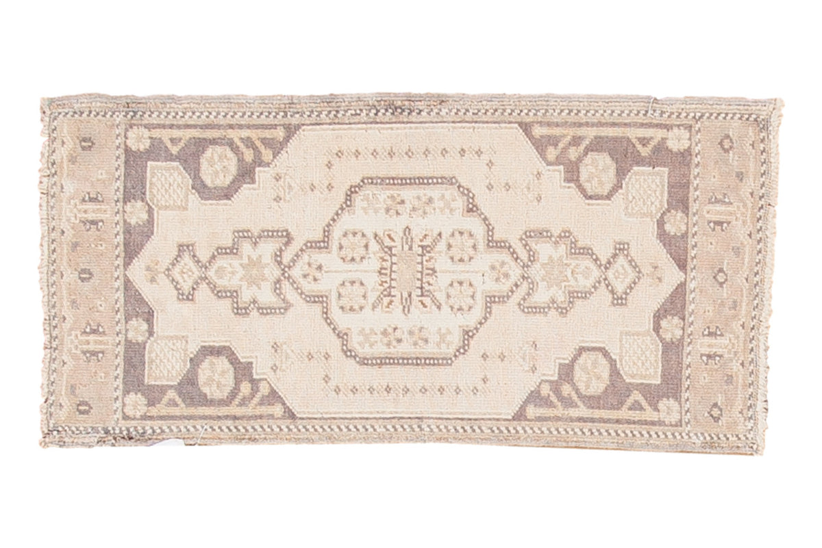 Vintage Oushak rug with a scalloped medallion, geometric spandrels, in pale ivory and charcoal.