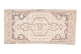 Vintage Oushak rug with a scalloped medallion, geometric spandrels, in pale ivory and charcoal.