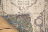 Vintage Oushak rug's colorful hand-knotted reverse, showing the tight weave, fringe, and short pile.