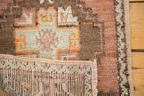 Vintage Oushak rug detail: hand knotted back, short pile, geometric brown, ivory pattern.