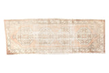 Vintage distressed Oushak runner featuring faded ivory and apricot geometric medallions.