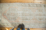 Distressed vintage Oushak runner detail with faded primitive medallions and soft blush tones.