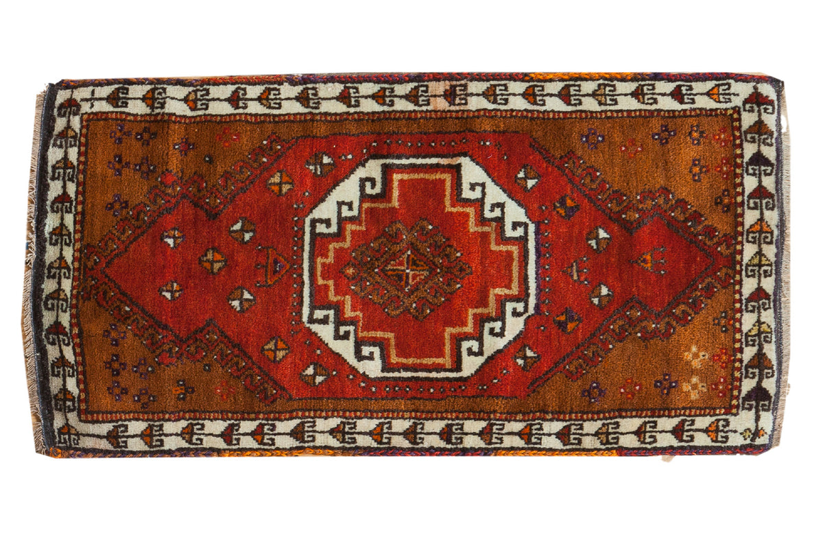 Vintage Oushak rug mat, central brick red medallion, brown field, ivory geometric border.