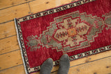 Close-up of a vintage Oushak rug runner's cherry red field, geometric border, and thick pile.