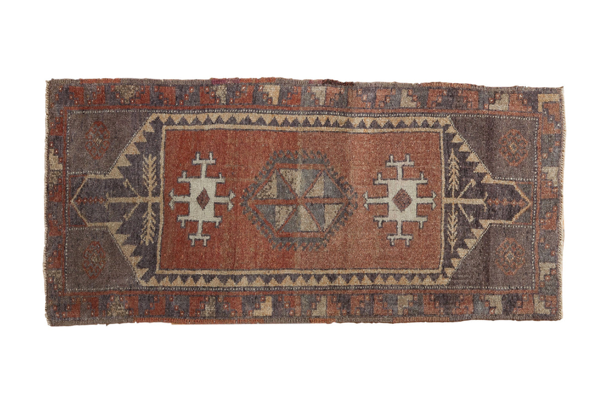 Vintage Oushak runner with abrashed copper lozenge medallion and geometric grey, ivory patterns.