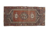 Vintage Oushak runner with abrashed copper lozenge medallion and geometric grey, ivory patterns.