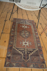 Abrashed copper field on vintage Oushak runner, highlighting geometric medallion and serrated designs.