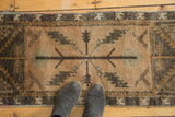 Oushak rug runner's central serrated leaf motif in apricot, charcoal, turquoise.