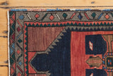 Vibrant rectilinear patterns and contrasting colors on a vintage Oushak rug corner.