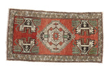 Vintage Turkish Oushak runner with serrated medallion, madder red field, and floral border.
