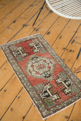 Serrated medallion and germinating plant motif on a vintage Oushak runner's madder red field.