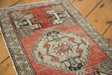Vintage Oushak rug runner detail: madder root red field, germinating plant, splayed floral border.