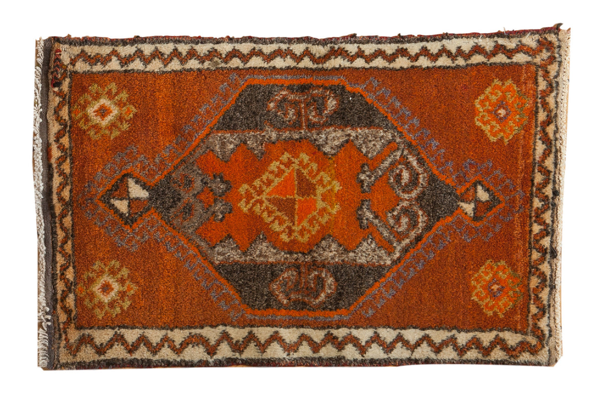 Vintage Oushak rug mat with a large tangerine, charcoal, and ivory geometric medallion, rams horn design. 1'11" x 2'10".