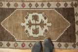 Vintage Oushak rug with natural brown, ivory geometric medallion and blush pink elements.