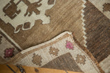 Oushak rug corner revealing the tight, hand-knotted foundation and blush pink wool detail.
