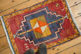 Vintage Oushak rug, navy blue medallion, tangerine and ivory pinwheel on cherry red field.