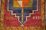 Geometric pinwheel diamond motif, thick pile, and cherry red field of the Oushak rug.