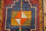 Thick pile pinwheel diamond motif of vintage Oushak rug in tangerine, saffron, ivory, navy.