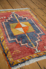 Thick pile texture with cherry red, navy, saffron, and tangerine geometric motifs.