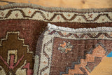 Thick hand-knotted pile, short fringe, and ivory geometric border of the Oushak rug.