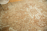 Antique Karaja carpet detail: Heriz-style serrated leaves and geometric motifs in pale bronze and sand.