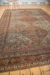 Vintage Persian Shiraz carpet with geometric triple medallions, pale slate blue field, and chestnut motifs.