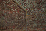 Vintage Shiraz carpet detail: knot heads visible, distressed chestnut brown, pale slate blue.