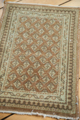 Distressed vintage Sivas rug with repeating mir boteh motif in blush, ivory, charcoal.