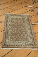 Distressed Sivas rug corner: repeating mir boteh motif in blush patina, ivory, and pale charcoal.