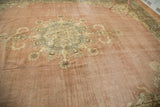 Distressed Kerman carpet with ornate trefoil medallion and blossoming pale blush and navy florals.