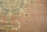 Distressed Kerman rug's ornate blossoming floral motifs in dusty rose and ivory.