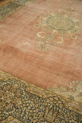 Distressed blush Kerman field featuring milfleur spandrels and ornate navy floral border.