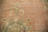 Distressed Kerman carpet with intricate blossoming milfleur patterns in blush, navy, and ivory.