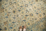 Aged North West Persian carpet showing detailed lattice motifs in ivory, navy, and saffron.