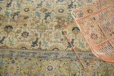 Distressed North West Persian carpet, detailing an ivory, navy, saffron geometric field and blue border.