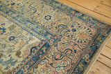 Distressed vintage North West Persian carpet shows textured rose, navy, and saffron lattice motifs.