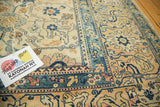 Distressed vintage North West Persian rug corner; navy, rose, and ivory geometric floral motifs.