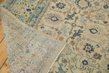 Distressed North West Persian carpet corner, revealing ivory field, blue motifs, and hand knotted reverse.