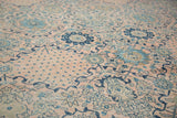 Vintage Kashan carpet detail with blush field, intricate sky blue florals, and navy vinery.