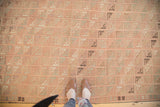 Repeating grid pattern in faded blush and ivory on a vintage Turkish Jijim rug.