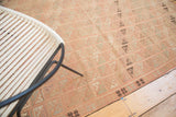 Repeating geometric grid of faded blush, ivory, and charcoal on vintage Turkish Jijim rug.