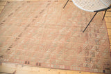 Faded blush and ivory grid pattern with diagonal flow on this vintage Turkish Jijim rug.