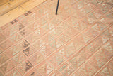 Turkish Jijim rug's repeating geometric squares in faded blush, charcoal, and ivory.