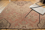 Vintage Jijim carpet corner, featuring repeating geometric panels in faded wine and ivory.
