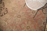 Repeating geometric panels and woven texture on this Turkish Jijim carpet in muted reds and browns.