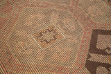 Hand-woven texture of vintage Jijim carpet with geometric panels in faded red and brown.