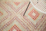 Hand-knotted Jijim carpet displaying geometric diamond lattice motifs in ivory, aubergine, cherry red.