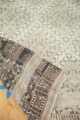 Folded distressed Jijim rug showing geometric lattice pattern, abrash, and woven back.