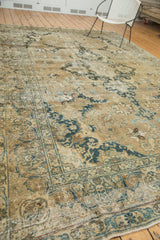Distressed Tabriz carpet corner with faded indigo and powder blue floral motifs.